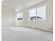 Bedroom featuring neutral carpet, light gray walls, and big windows with lots of natural light at 6834 Merseyside Ln, Castle Pines, CO 80108