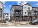 Modern townhome showcasing a contemporary design, a fenced yard, and a private balcony on the second floor at 6834 Merseyside Ln, Castle Pines, CO 80108