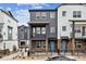 Charming two-story townhome with brick accents, a fenced yard, and a private balcony on the second floor at 6834 Merseyside Ln, Castle Pines, CO 80108