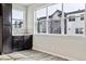 Cozy kitchen nook featuring dark cabinetry, tile backsplash, and large windows offering neighborhood views at 6834 Merseyside Ln, Castle Pines, CO 80108