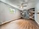 Finished basement showcasing hardwood floors, a ceiling fan, and double glass doors to the exterior at 12991 E Idaho Dr, Aurora, CO 80012