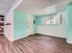 Finished basement space with light blue walls, wood-look flooring, and a window at 12991 E Idaho Dr, Aurora, CO 80012