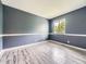 Bedroom with stylish gray-blue walls, and neutral floors bathed in natural light at 12991 E Idaho Dr, Aurora, CO 80012
