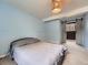 Bedroom with a gray bed, barn doors to the outside and a light fixture at 12991 E Idaho Dr, Aurora, CO 80012