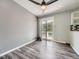 Dining area with ceiling fan, sliding doors to a deck, and wood-look flooring at 12991 E Idaho Dr, Aurora, CO 80012