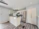 Kitchen with stainless steel appliances, island, and pot rack above the island at 12991 E Idaho Dr, Aurora, CO 80012