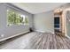 Bright living room with large window, gray walls, and wood-look flooring at 12991 E Idaho Dr, Aurora, CO 80012