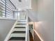 Bright stairway with modern railing that leads to the main floor at 12991 E Idaho Dr, Aurora, CO 80012