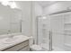 Bathroom featuring a glass-enclosed shower, white tile, modern vanity, and ample natural light at 17847 Dandy Brush Dr, Parker, CO 80134
