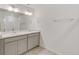 Bathroom featuring double sinks, modern vanity, white tile, and a glass enclosed shower at 17847 Dandy Brush Dr, Parker, CO 80134