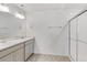 Bathroom featuring double sinks, modern vanity, white tile, and a glass enclosed shower at 17847 Dandy Brush Dr, Parker, CO 80134