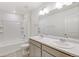 Bathroom featuring double sinks, tub, and tile at 17847 Dandy Brush Dr, Parker, CO 80134