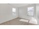 Bright bedroom with neutral carpeting and natural light from two windows at 17847 Dandy Brush Dr, Parker, CO 80134