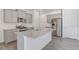 Bright kitchen with gray cabinets, stainless steel appliances, and an island with a granite countertop at 17847 Dandy Brush Dr, Parker, CO 80134