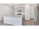 Modern kitchen boasts a large island with granite countertops, stainless steel appliances, and light gray cabinets at 17847 Dandy Brush Dr, Parker, CO 80134