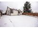 Backyard of home featuring fenced yard and fresh snow at 1940 W 101St Ct, Thornton, CO 80260