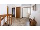 Foyer with neutral walls, wood accents, bench seating, and views of the interior through doorways and stairs at 1940 W 101St Ct, Thornton, CO 80260