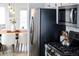 Modern kitchen featuring stainless steel appliances and a view into the adjacent dining area at 1940 W 101St Ct, Thornton, CO 80260