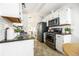 Contemporary kitchen with stainless steel appliances and open layout with a view to the living room at 1940 W 101St Ct, Thornton, CO 80260