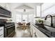 Well-lit kitchen featuring modern appliances, granite countertops, and a cozy breakfast nook at 1940 W 101St Ct, Thornton, CO 80260