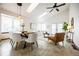 Open-concept living and dining area, highlighted by modern lighting and vaulted ceilings at 1940 W 101St Ct, Thornton, CO 80260