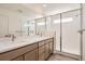 Modern bathroom with double vanity, quartz countertop, and a large walk-in shower at 1242 S Algonquian, Aurora, CO 80018