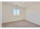 Well-lit bedroom featuring neutral-toned carpet and a sizable window at 1242 S Algonquian, Aurora, CO 80018