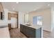 Modern kitchen island with a white quartz countertop and gray shaker cabinets at 1242 S Algonquian, Aurora, CO 80018