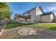 Spacious backyard featuring a well-maintained lawn, a fire pit, and a pergola-covered patio at 13018 Niagara Way, Thornton, CO 80602