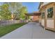 A covered patio area featuring string lights and a hammock, with a fenced yard beyond at 13018 Niagara Way, Thornton, CO 80602
