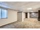 Finished basement with carpet, window, wood accent walls, and stylish ceiling tiles at 13018 Niagara Way, Thornton, CO 80602