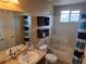 Bathroom including a sink, toilet, tub and crates for storage at 13018 Niagara Way, Thornton, CO 80602