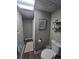 Bathroom featuring a decorative ceiling, neutral paint, wood-look flooring, and modern toilet at 13018 Niagara Way, Thornton, CO 80602