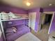 A purple bedroom featuring a bunk bed and a large closet at 13018 Niagara Way, Thornton, CO 80602