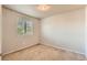Neutral bedroom showcasing plush carpet, window with blinds, and ample natural light for a serene ambiance at 13018 Niagara Way, Thornton, CO 80602