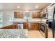 Well-equipped kitchen with stainless appliances, granite countertops, and ample cabinet space at 13018 Niagara Way, Thornton, CO 80602