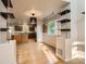 Open-concept kitchen with stainless steel appliances and an eat-in area with stylish pendant lighting at 13018 Niagara Way, Thornton, CO 80602