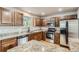 Kitchen with granite countertops, stainless steel appliances, wooden cabinets, and hardwood floors at 13018 Niagara Way, Thornton, CO 80602