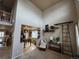 Bright living room with vaulted ceilings, a decorative ladder, and an open view into the dining area and kitchen at 13018 Niagara Way, Thornton, CO 80602