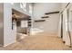 Open-concept living room with high ceilings, carpeted floors, and stylish wooden shelves at 13018 Niagara Way, Thornton, CO 80602