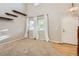 Bright living room with large windows, neutral carpet, and high ceilings for a modern feel at 13018 Niagara Way, Thornton, CO 80602