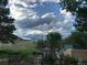 Backyard with stone pathway, chairs, and mountain views at 12041 Twilight St, Longmont, CO 80503