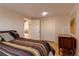 Cozy basement bedroom with striped bedding and built-in closet at 12041 Twilight St, Longmont, CO 80503