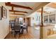 Dining area and kitchen with hardwood floors and wood beams at 12041 Twilight St, Longmont, CO 80503