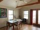 Dining area with exposed beams, tile floors and plenty of natural light at 12041 Twilight St, Longmont, CO 80503