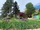 Exterior view of a charming home with landscaping and purple irises at 12041 Twilight St, Longmont, CO 80503