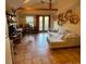 Bright living room with sectional sofa, tile floors, and custom shelving at 12041 Twilight St, Longmont, CO 80503