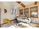 Living area with wood beams, a wood burning stove and large windows at 12041 Twilight St, Longmont, CO 80503