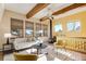 Bright living room with wood beams, wood burning stove and large windows at 12041 Twilight St, Longmont, CO 80503