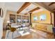 Bright living room with wood beams, wood burning stove and large windows at 12041 Twilight St, Longmont, CO 80503